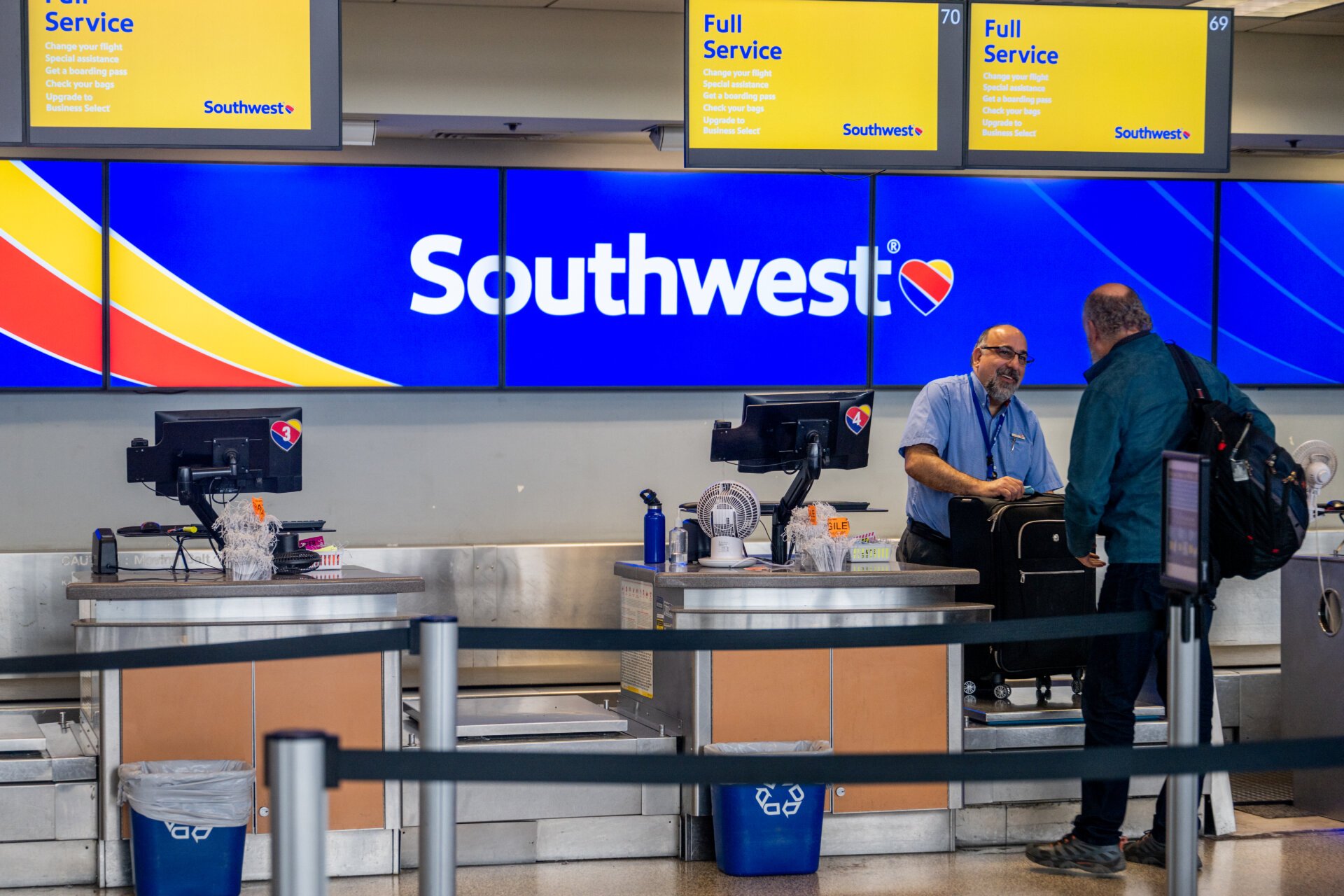 A Southwest Airlines employee assists a passenger during their check-in at the Austin-Bergstrom International Airport on April 18, 2023 in Austin, Texas. Southwest Airlines suffered a brief disruption in operations earlier this morning after a computer firewall issue forced the company to delay many of its flights. (Photo by Brandon Bell/Getty Images)